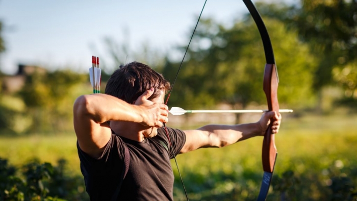 man shooting an arrow