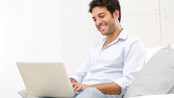 man typing on laptop